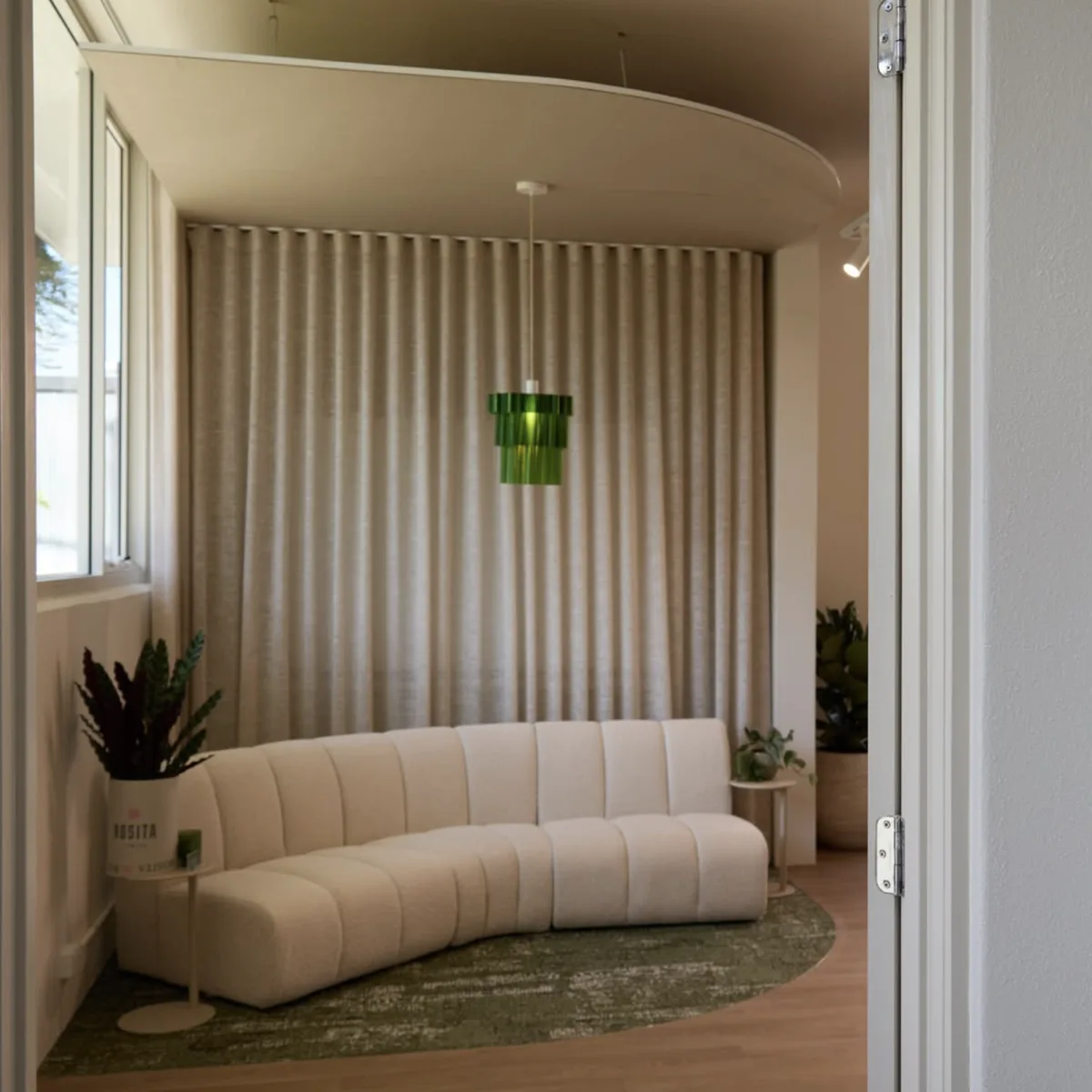 Breakout lounge with a curved sofa beside a window