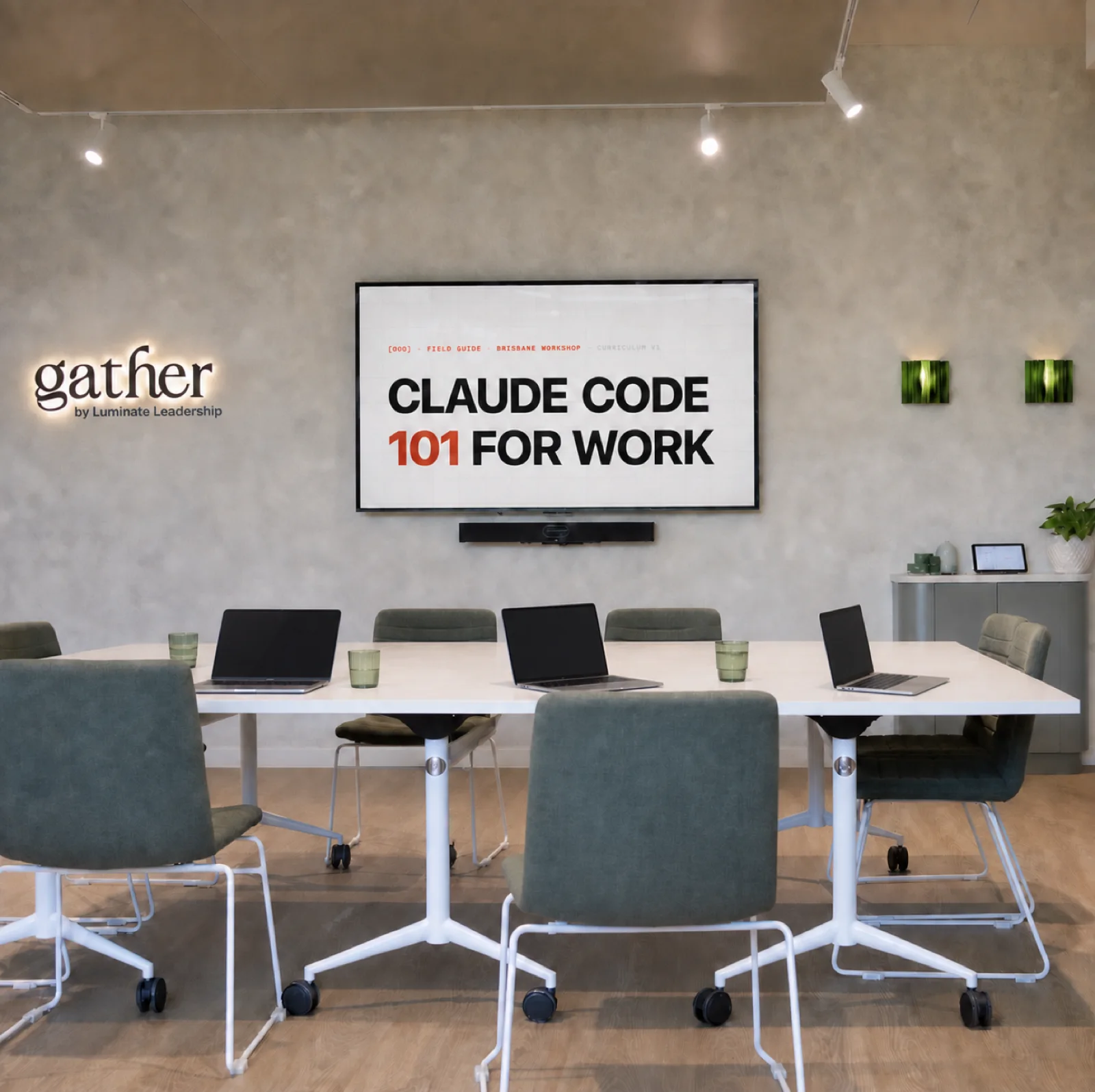 The workshop room at Gather Bulimba — one table, laptops out and the curriculum on screen